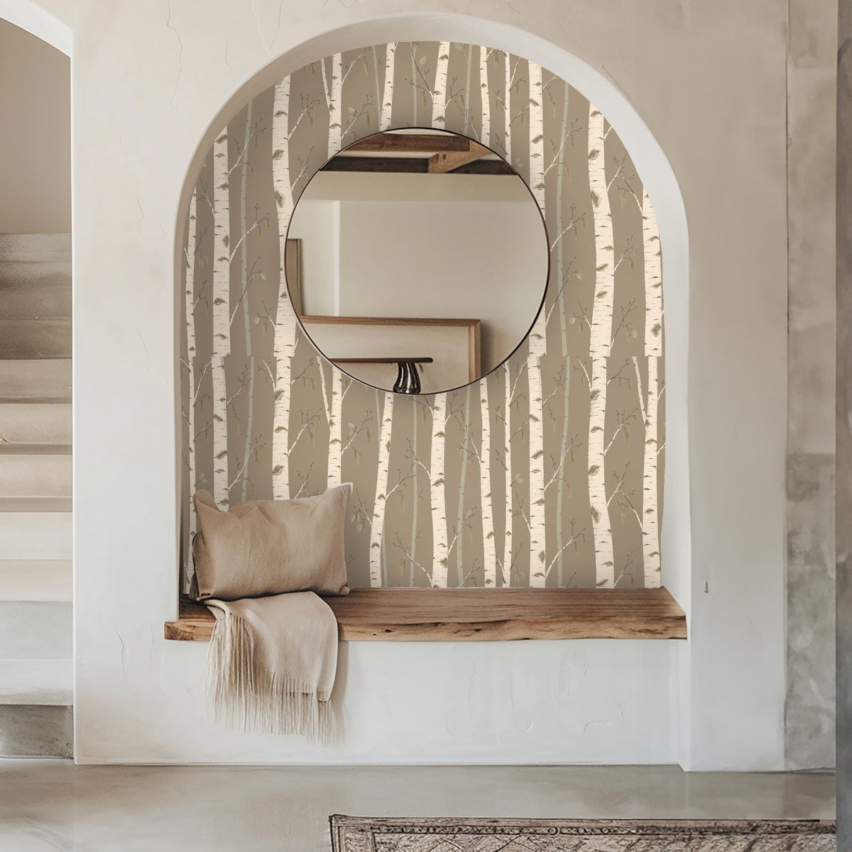 Bedroom close-up with Silver Stillness wallpaper behind an olive-green scalloped headboard, showing scale and trunk spacing.