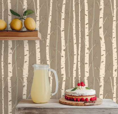 Nursery wall with a crib placed in front of the birch pattern, showing how the design reads softly in a child's room.