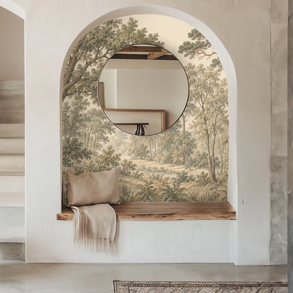 Entryway alcove: arched niche with round mirror reflecting the mural’s layered trees and meadow beyond.