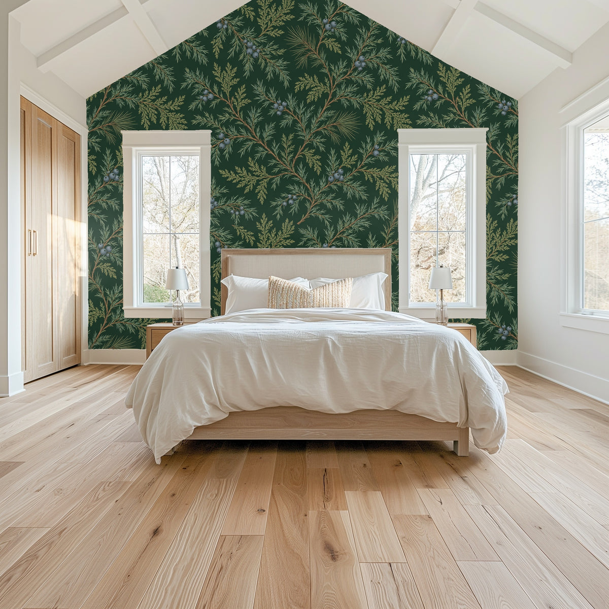 Vaulted bedroom wall covered in Juniper Drift wallpaper; pattern frames windows and headboard for an anchored focal wall