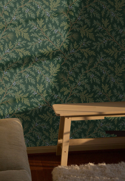 Repeat tile of Juniper Drift wallpaper showing juniper branches, olive fronds and clusters of slate-blue berries on a deep forest green base
