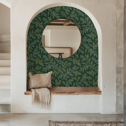 Narrow arched entryway lined in Juniper Drift wallpaper with round mirror and bench, showcasing the pattern at human scale