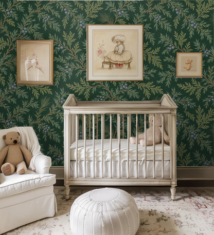 Nursery wall dressed in Juniper Drift wallpaper behind a vintage crib and framed prints, pattern adding classic botanical charm