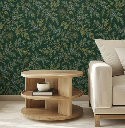 Close living room view of Juniper Drift wallpaper behind a low wood coffee table and neutral sofa, highlighting needle detail