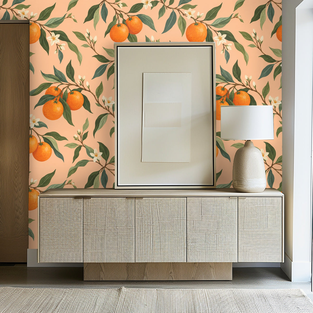 Entryway vignette with the citrus wallpaper behind a low console and framed art.