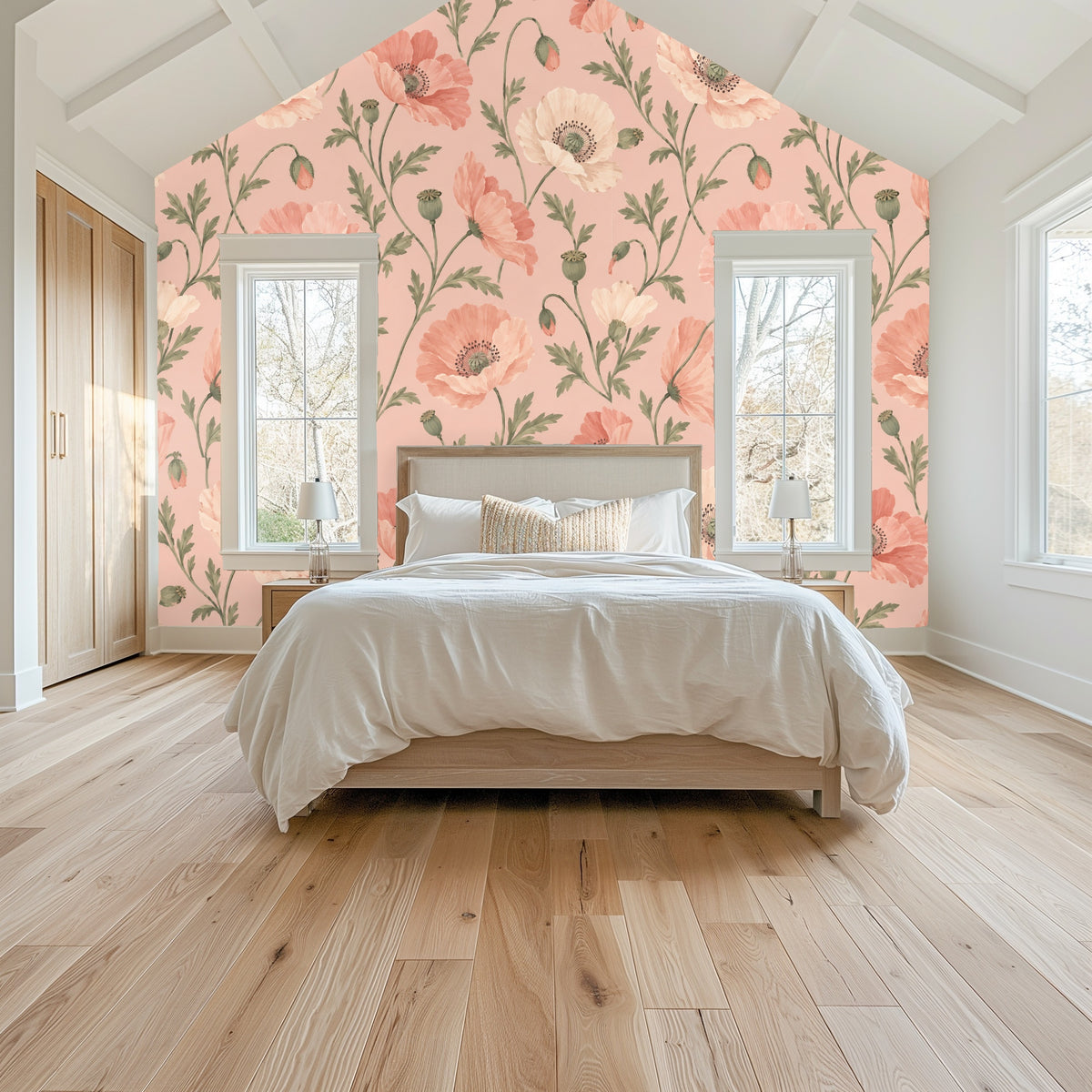 Bedroom vignette with gable wall covered in large-scale blush poppy wallpaper behind a simple bed.
