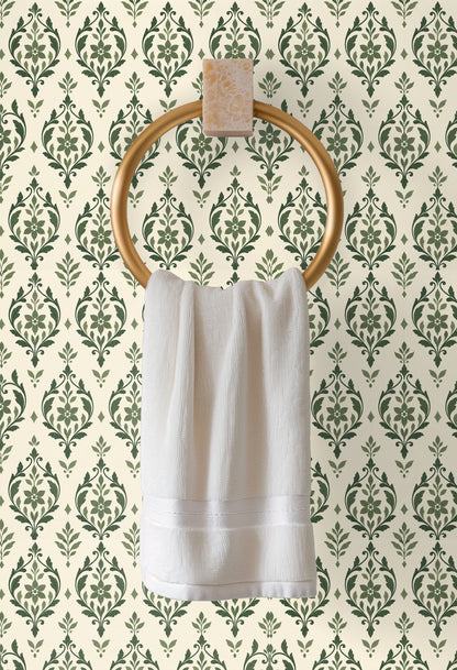 Bright minimal space with full-wall sage arabesque mural and sculptural decor in foreground