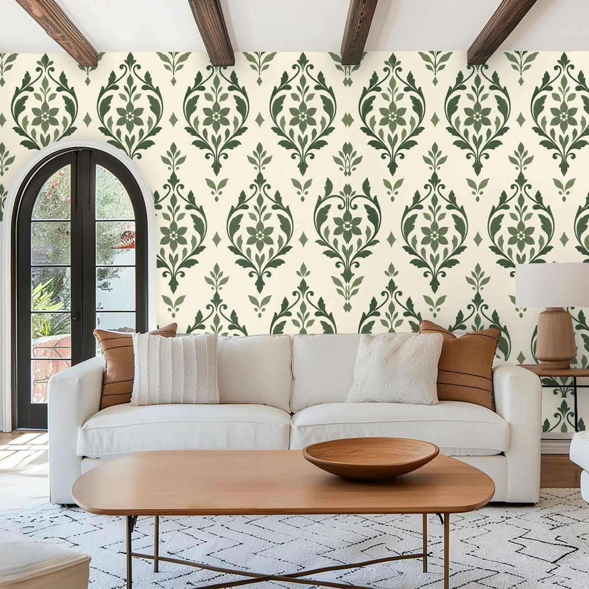 Bedroom wall with green upholstered bedframe and sage arabesque wallpaper behind the bed