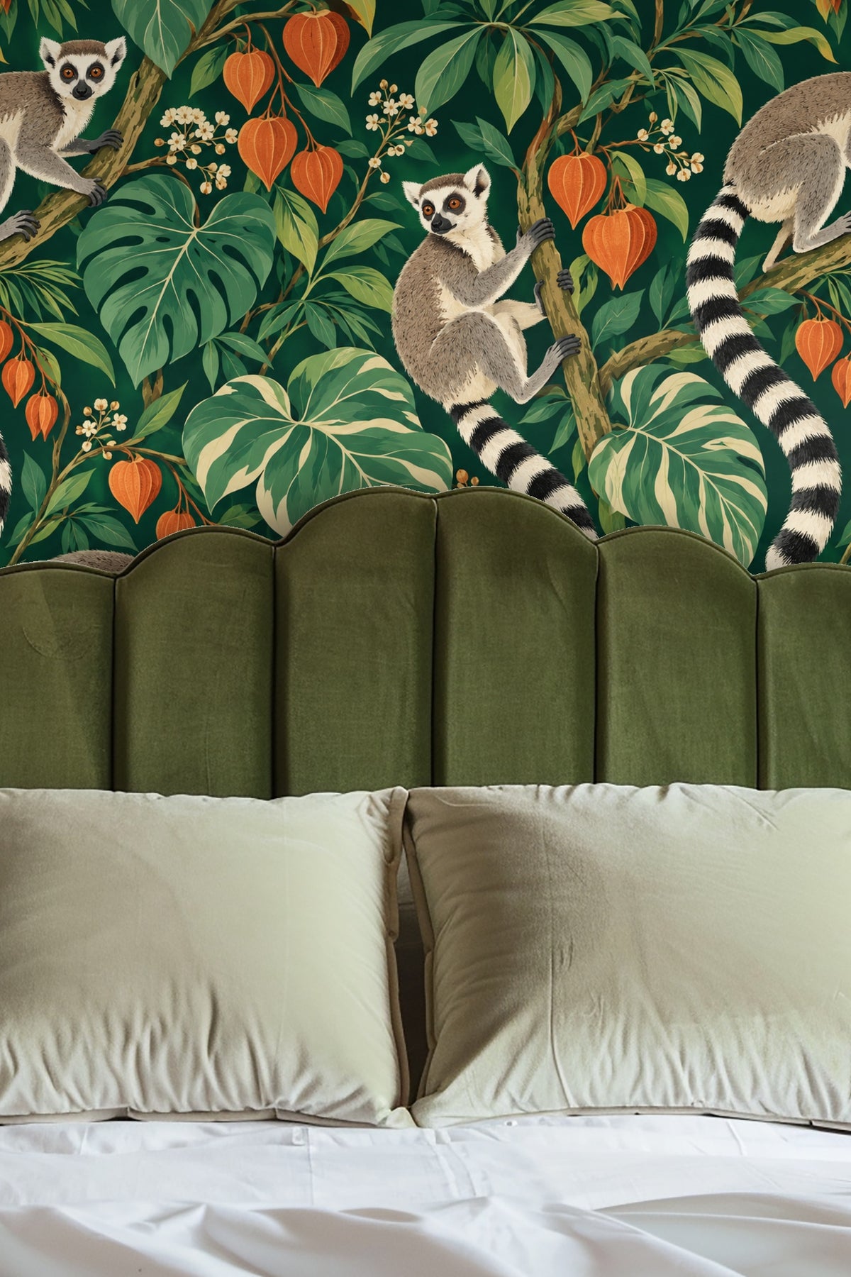 Entryway with arched alcove lined in vibrant lantern orange and green foliage wallpaper with lemurs climbing branches, reflecting in a round