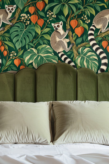 Entryway with arched alcove lined in vibrant lantern orange and green foliage wallpaper with lemurs climbing branches, reflecting in a round