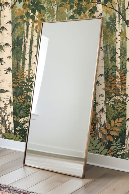 View of golden and green leaves amid birch trunks