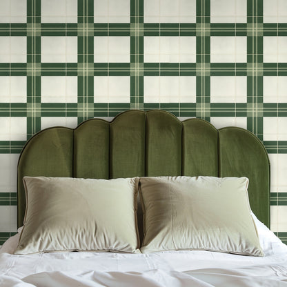 Blue velvet sofa framed by Forest Loom Plaid Wallpaper, illustrating the pattern as a living room feature wall with bold checked rhythm.