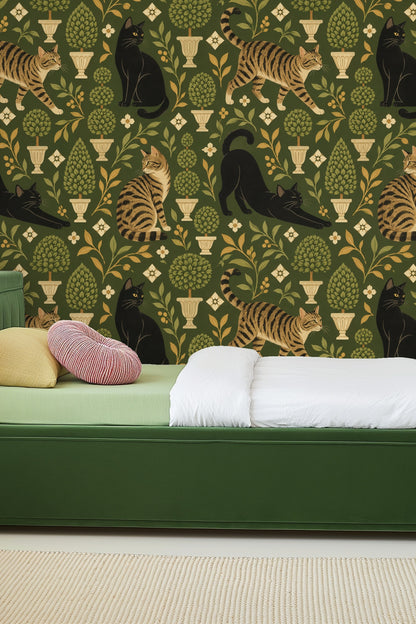 Living room scene showing olive green wallpaper with cat and plant motif behind curved white sofa and red chair