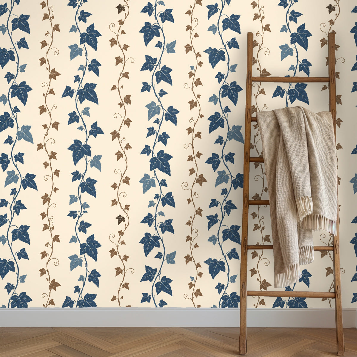 Nursery wall with wallpaper featuring vertical twining ivy stripes behind a simple wooden crib