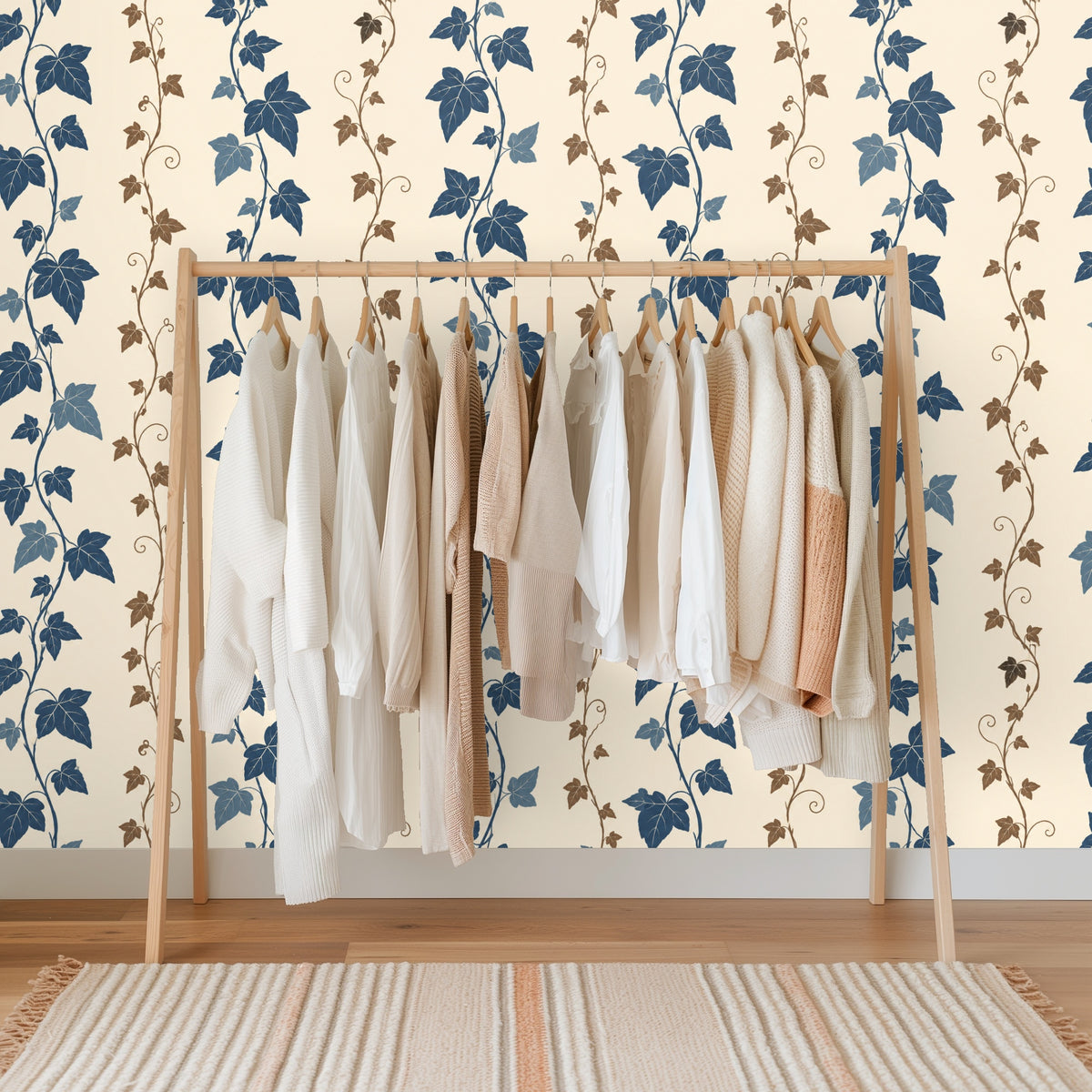 Wallpaper detail behind a leaning wooden ladder with a folded cream blanket draped over a rung