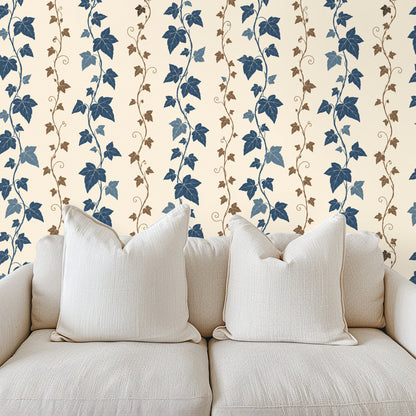 Bedroom headboard against a wall of ivy stripe wallpaper, illustrating a feature-wall application
