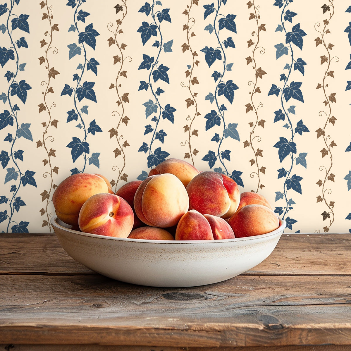 Full-width vignette of wallpaper behind a sofa with neutral textured pillows