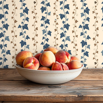 Full-width vignette of wallpaper behind a sofa with neutral textured pillows