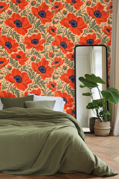 Living room corner with plush white cushioned chair and round wood table against vivid persimmon anemone wallpaper on peach background