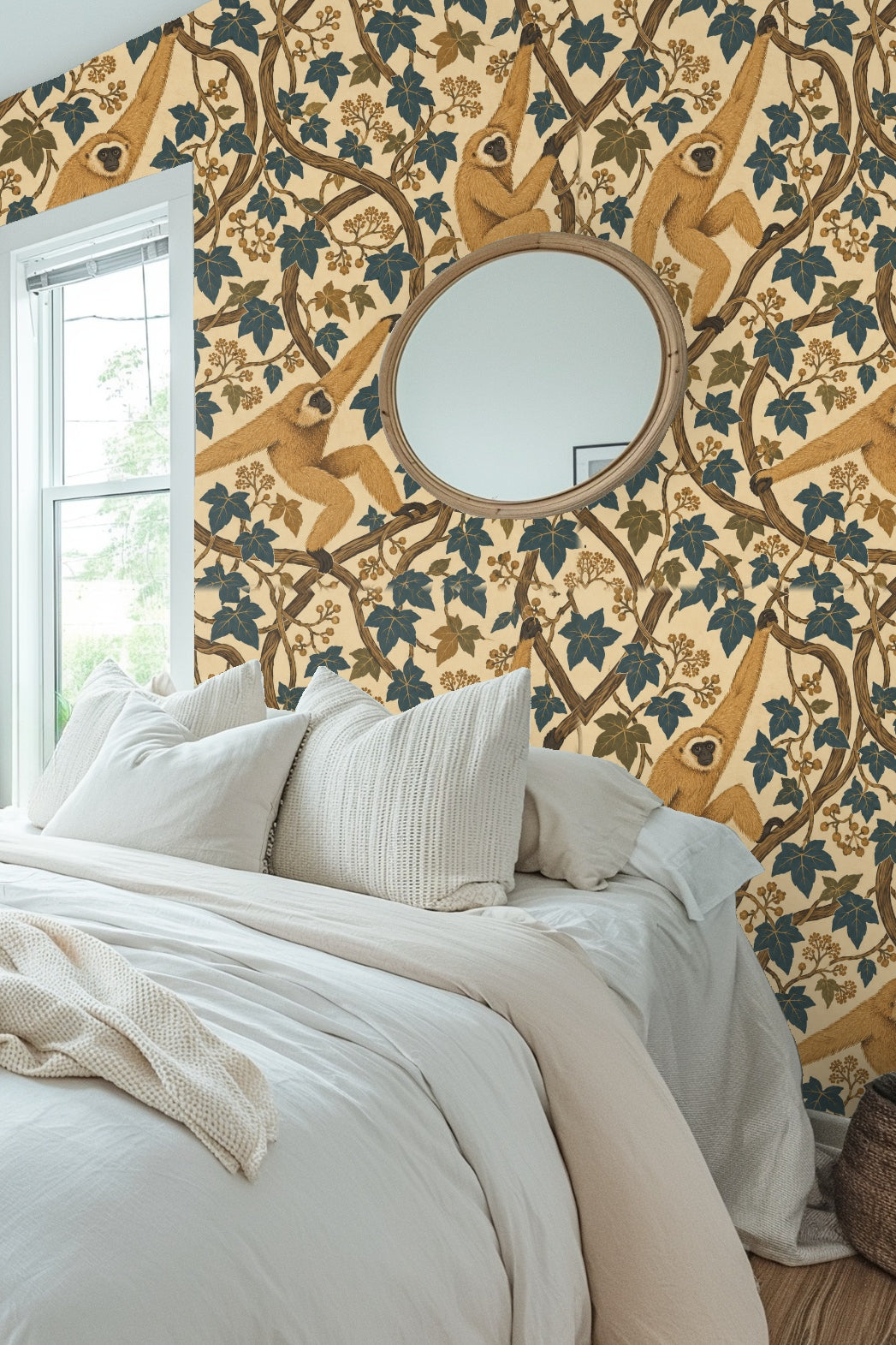 Close-up of a living room wall covered with golden gibbons and ivy wallpaper, paired with pink sofa and peach cushion