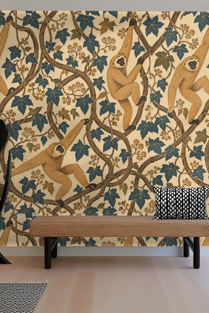 Bedroom wall showcasing wallpaper with golden gibbons amid blue and olive ivy climbing vines, seen next to a round mirror and light bedding