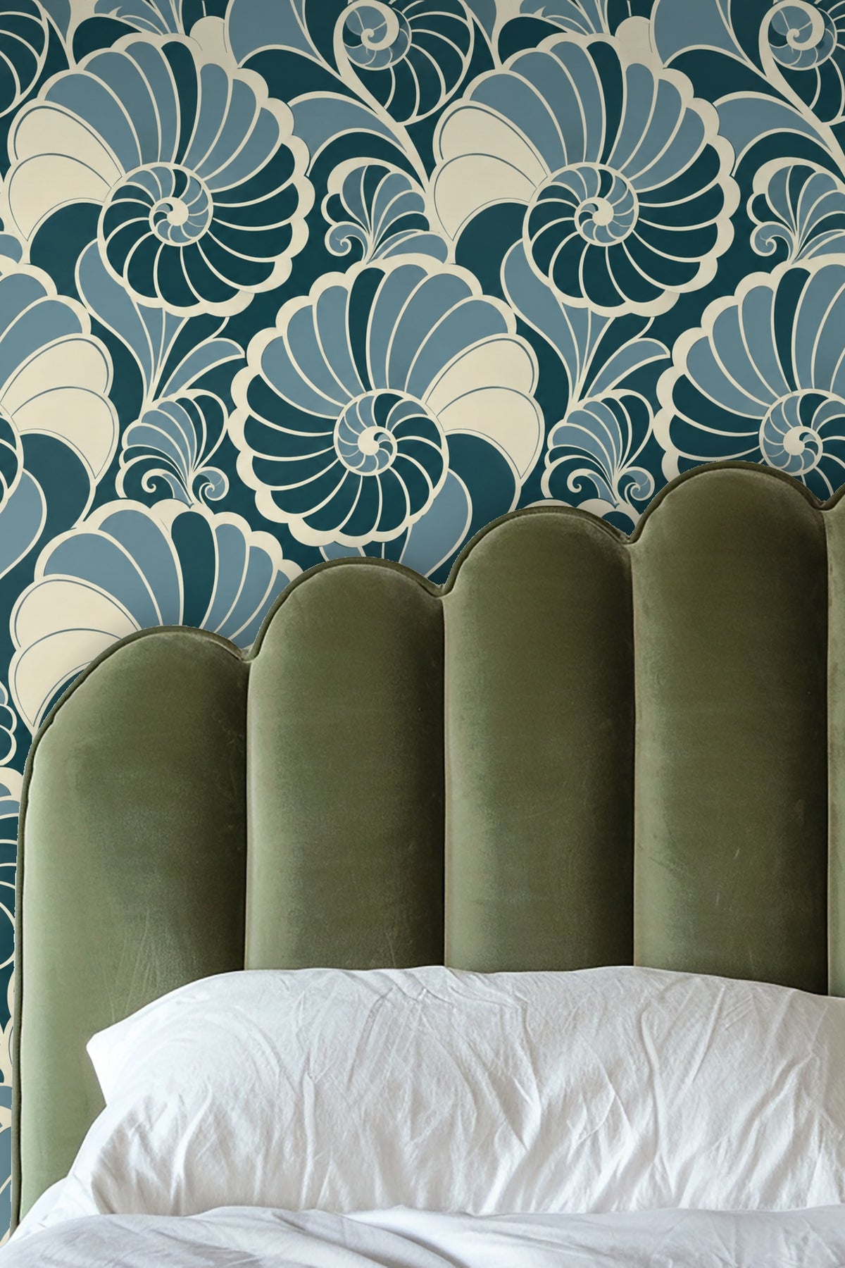 Living room with beige sofa beneath wallpaper of bold stylized nautilus shell motifs in teal and blue.