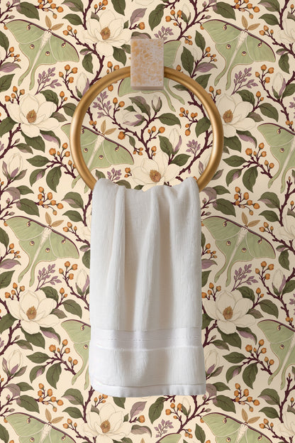 Magnolia flower cluster with cream petals and yellow center buds among green and lavender leaves