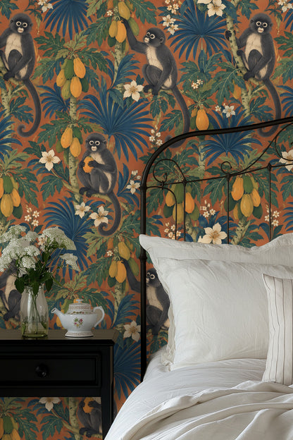Wide shot of living room couch against bold patterned wall filled with tropical fruit and animals