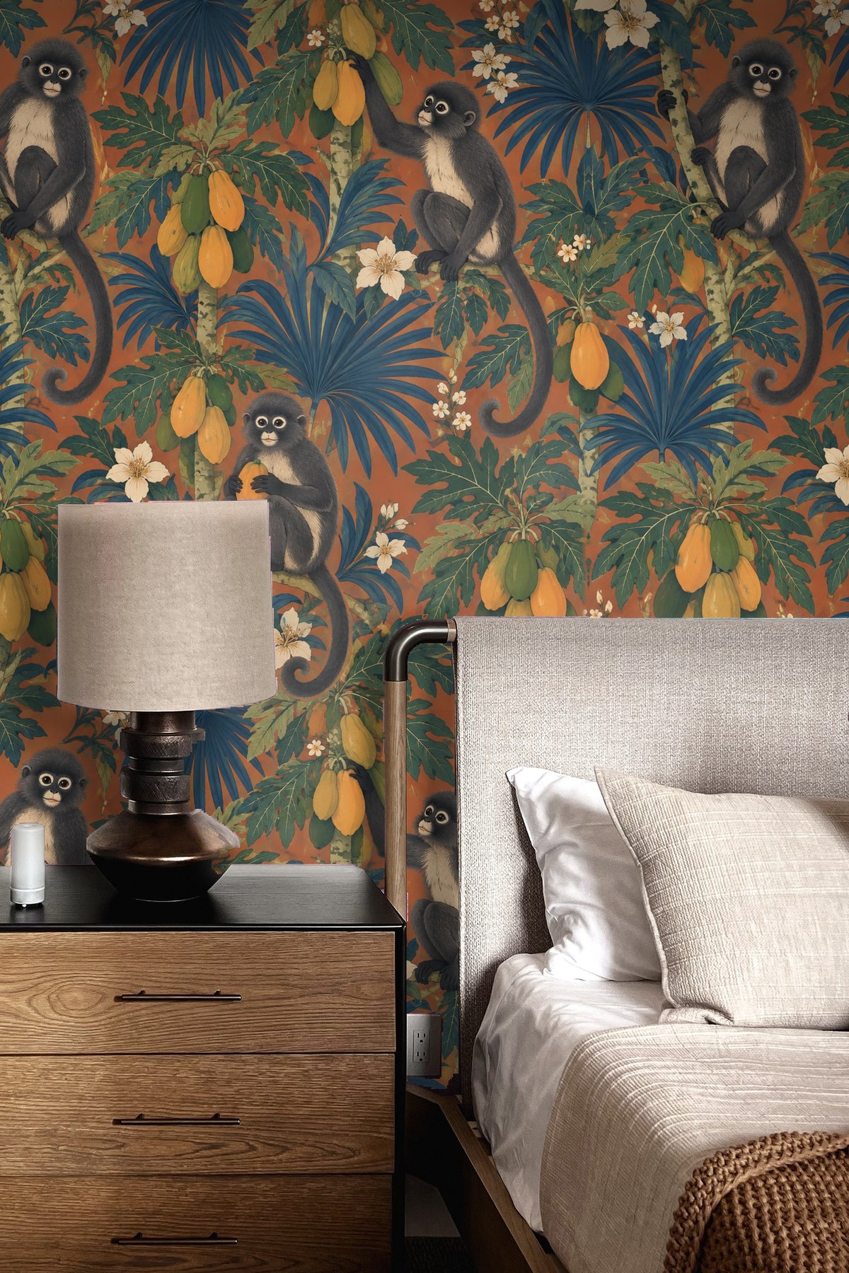 Multiple monkeys interacting with papaya clusters and white tropical flowers on terracotta wall