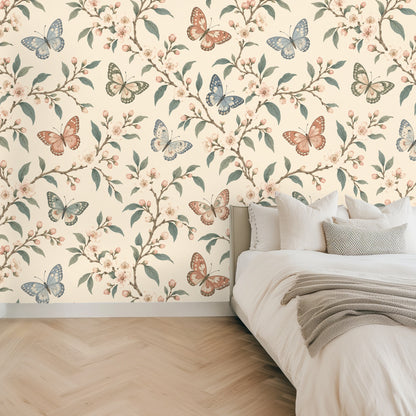 Close-up of Porcelain Flutter wallpaper showing butterflies, cherry blossoms and muted sage leaves on a warm cream background