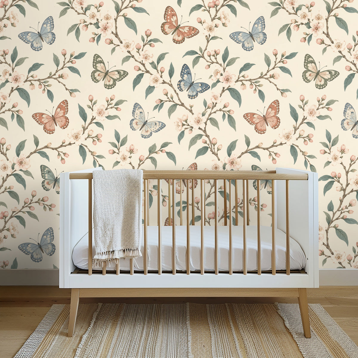 Living room vignette with a light linen sofa against the butterfly-and-blossom wallpaper, showing how the pattern reads across a full wall