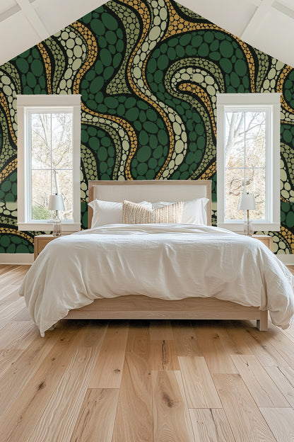 Bright bedroom with vaulted ceiling, bed framed by vibrant Cypress Scale Mosaic wallpaper in greens and earth tones.