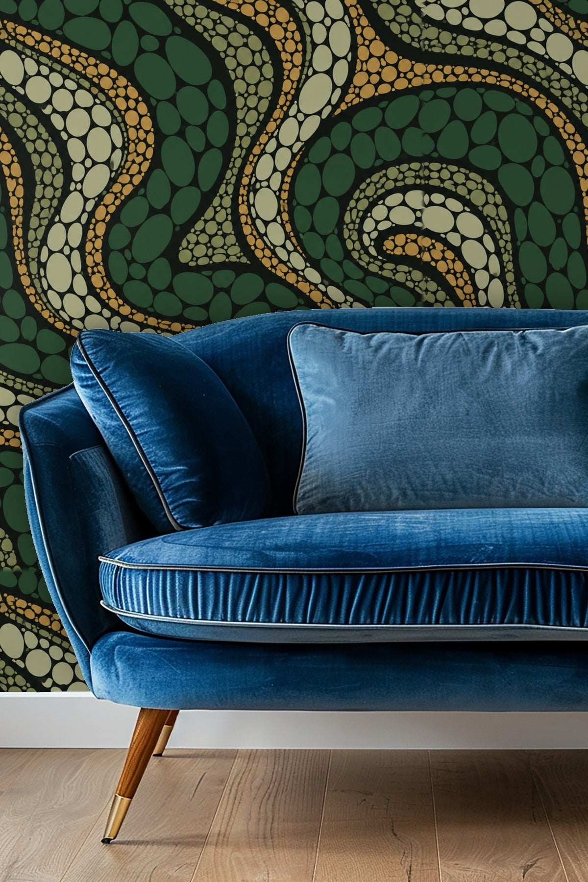Living room with blue velvet sofa against wall covered in Cypress Scale Mosaic wallpaper with flowing scale-like shapes.