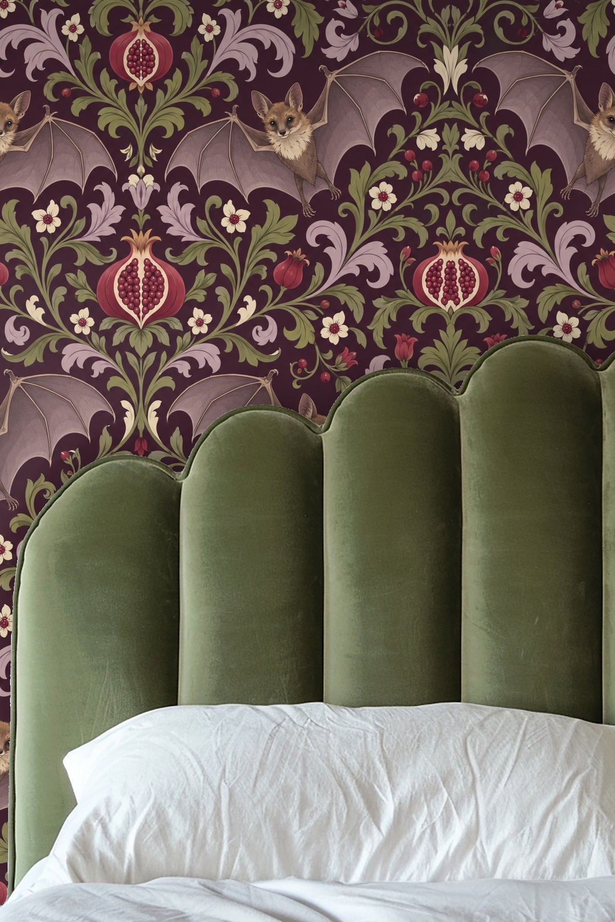 Close-up of leather armchair against wallpaper with flying bats and intricate pomegranate foliage pattern.