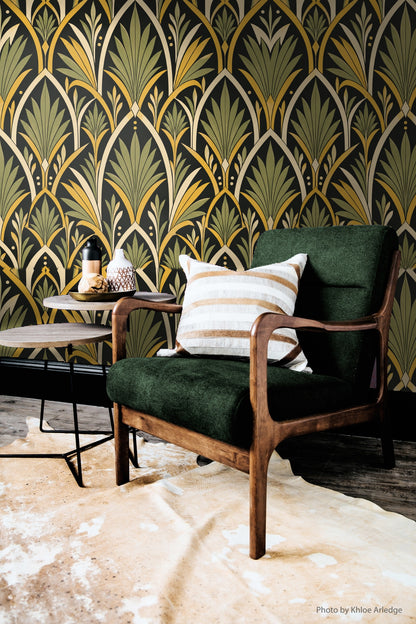 Corner photo showing wallpaper with overlapping fan leaves and minimal dot accents in cream