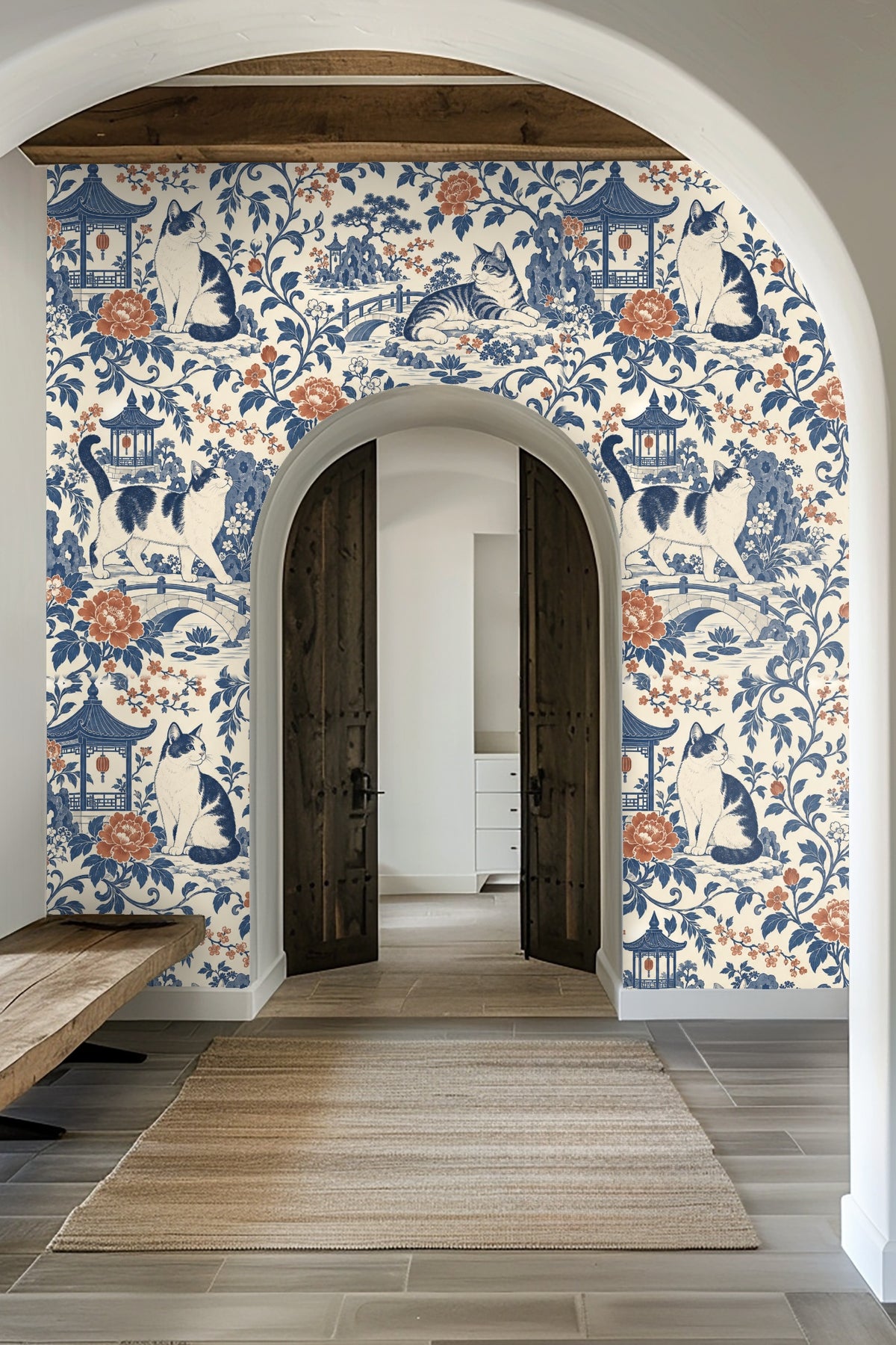 Blue velvet sofa set against indigo and terracotta cats wallpaper with pagodas and floral motif