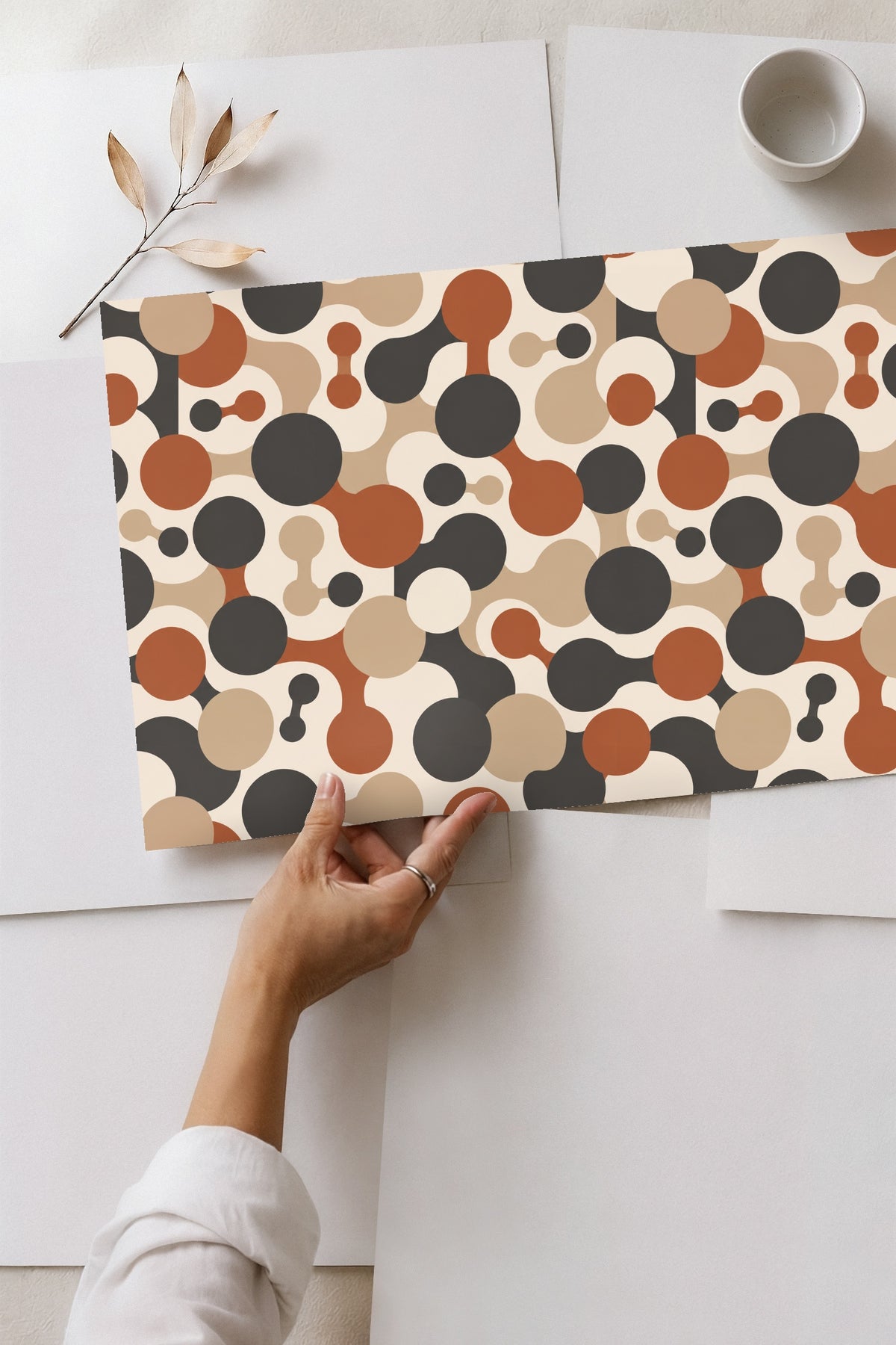 Clean lines of wooden cabinet contrasting with playful circles of Cinder Orbit Chains wallpaper.