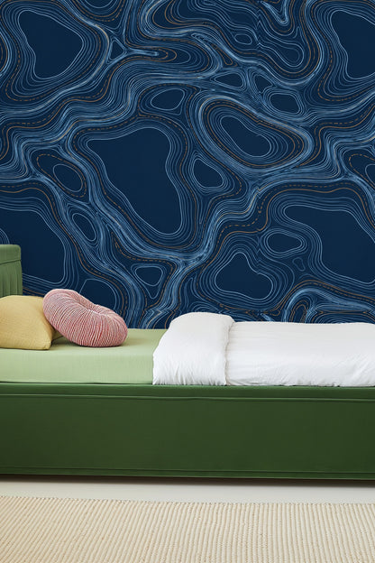 Midnight Ripples Engraving wallpaper in a living room with orange sofa and warm decor accents
