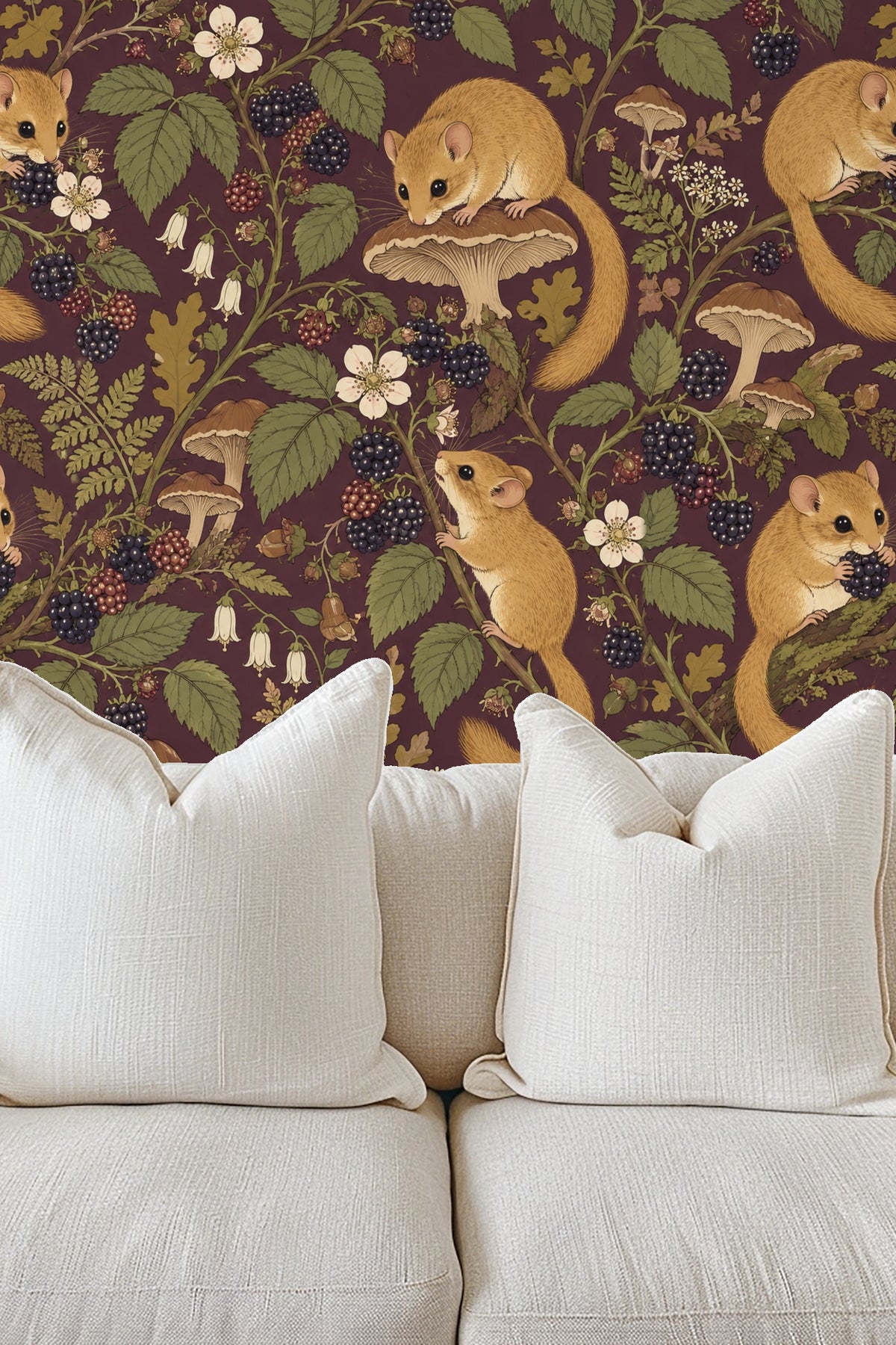Bedroom interior with Plum Dormouse Bramble wallpaper behind a beige upholstered bed and wooden bedside table with lamp
