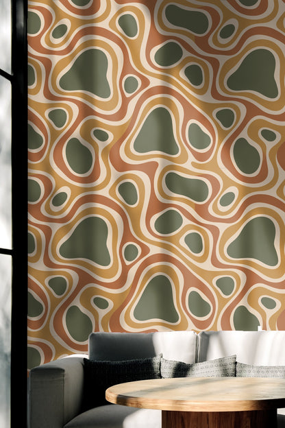 Rounded shapes overlapping in soft ochre and terracotta hues.