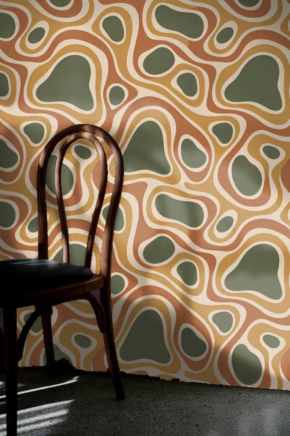 Series of connected oval and irregular forms in muted olive and cream.