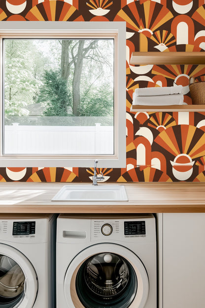 Wallpapered wall in a side table setting with a lit candle and delicate white flowers highlighting warm terracotta fan pattern