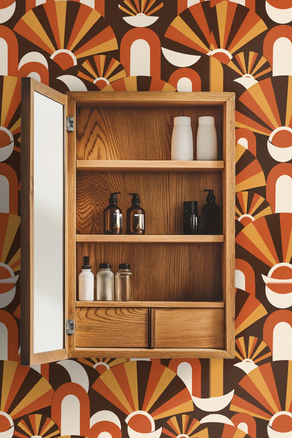 Laundry room with washing machines, shelving and a window, featuring bold orange and brown geometric fan wallpaper