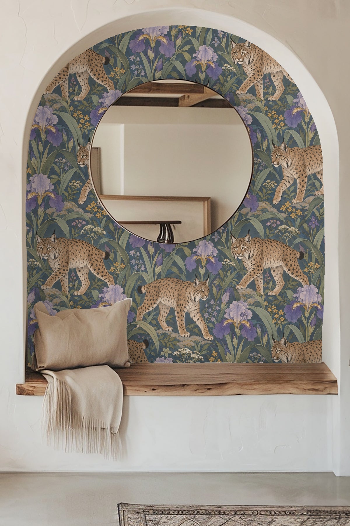 Room setting with a blue velvet couch against wallpaper showing lynxes and purple irises.