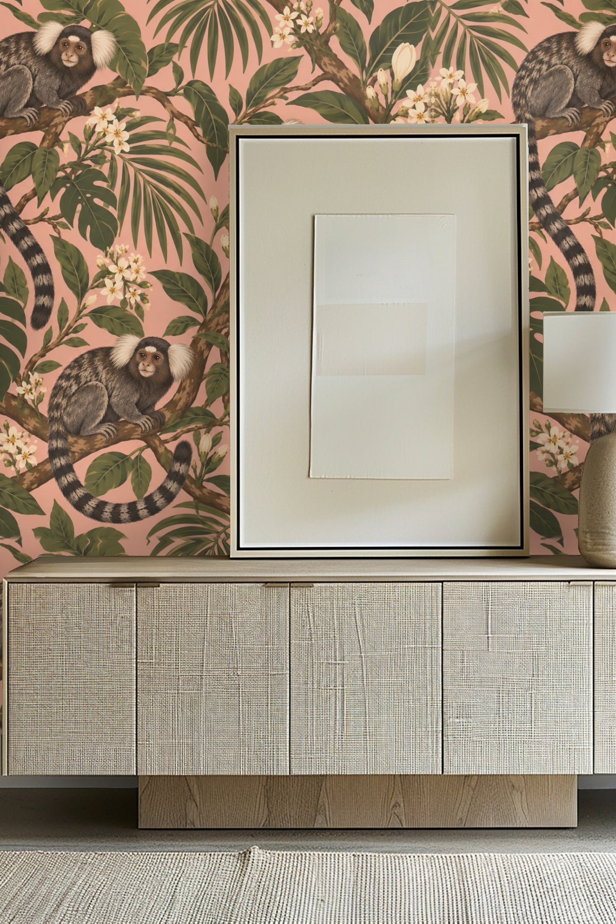 Wallpaper pattern with three marmosets perched on leafy branches against a pink background