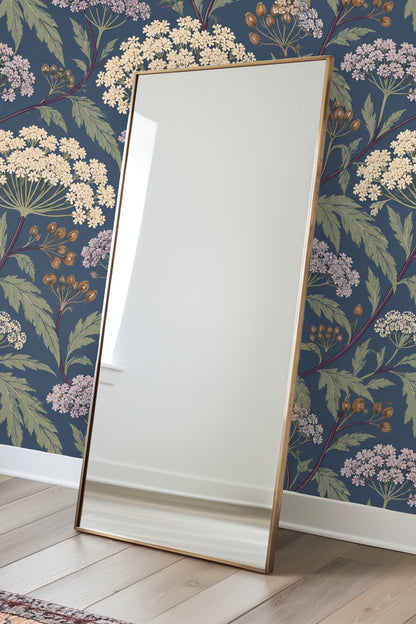 Soft lavender floral clusters with green leaves on deep blue wallpaper ground