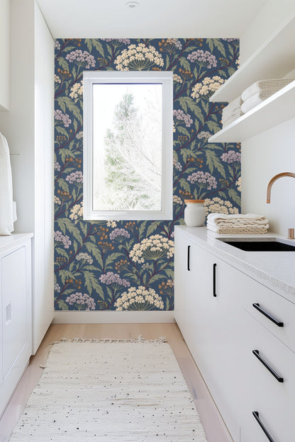 Detailed view of cream-colored umbel flowers and seed pods on dusky blue wallpaper