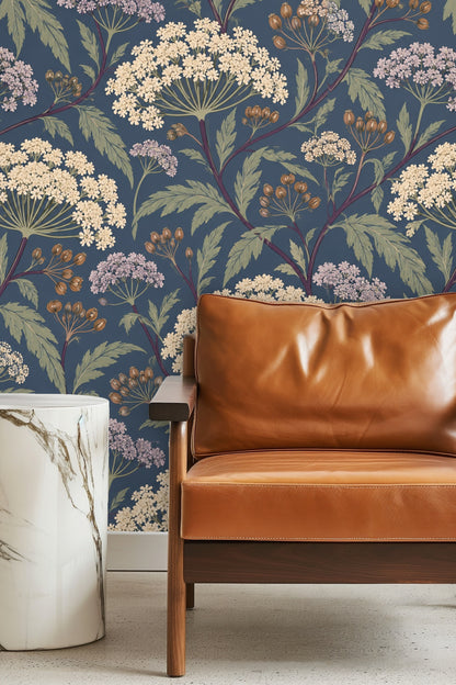 Bedroom with green velvet headboard against Dusky Umbel Lattice wallpaper in deep blue with floral umbels