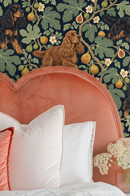 Bedroom wall with peach-colored headboard and wallpaper featuring spaniels and fig branches