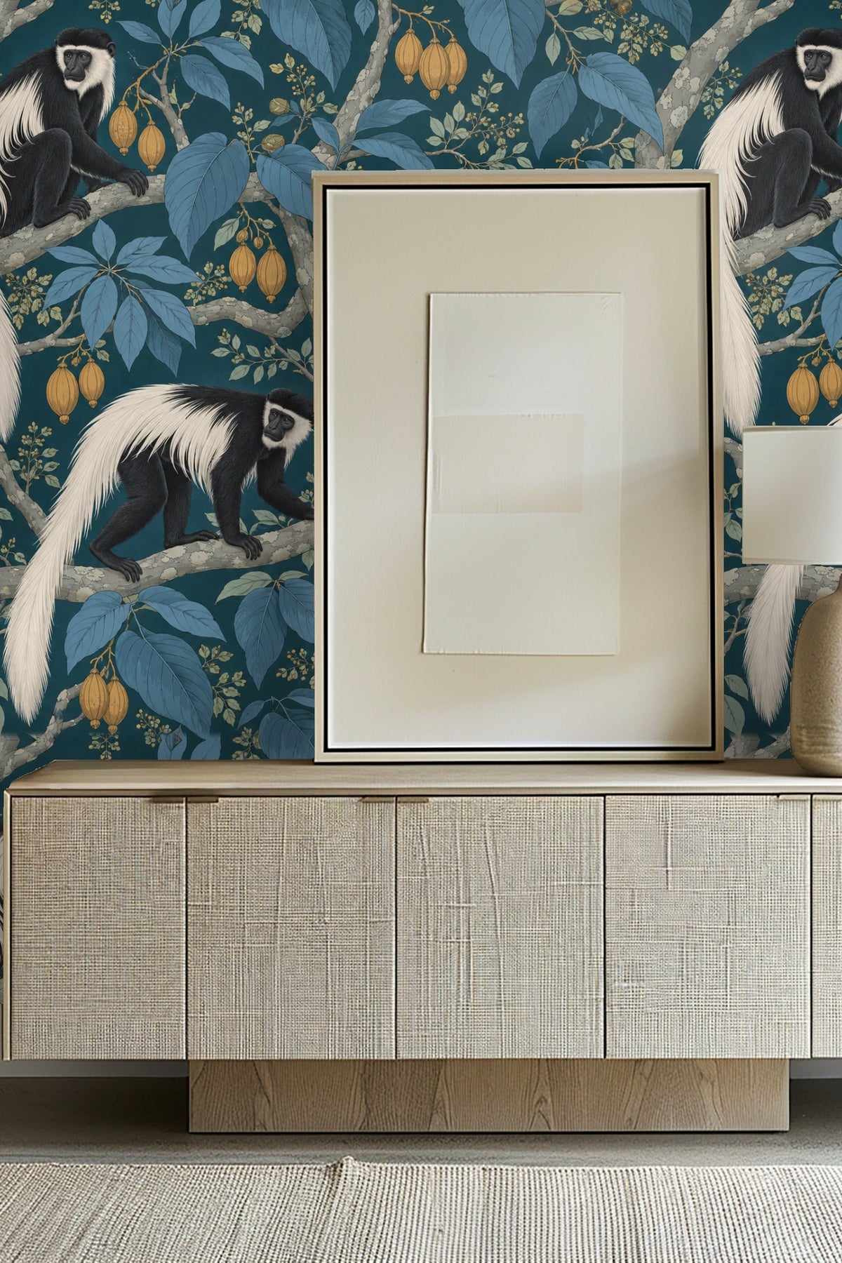 Bathroom scene with Moonstone Monkey Boughs wallpaper behind marble and gold towel ring